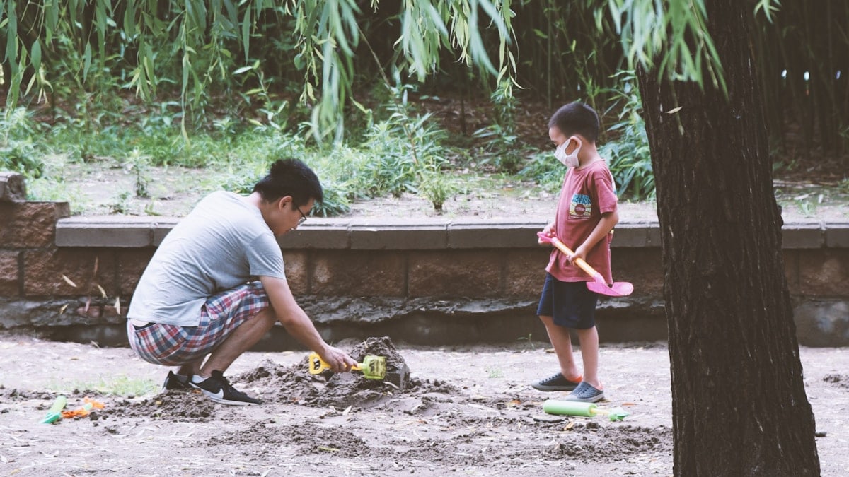 a person and a girl playing with a toy